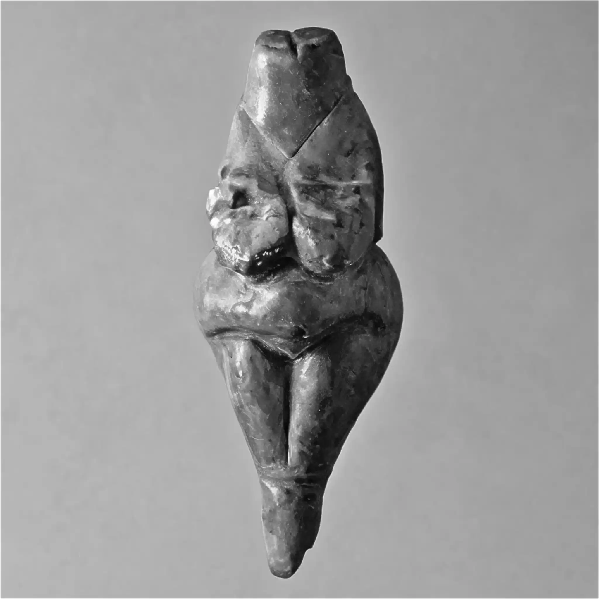 A venus figurine of a woman's body generated with custom AI in black and white. It has no head and no arms.